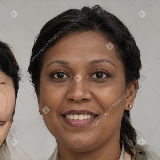 Joyful black adult female with medium  brown hair and brown eyes