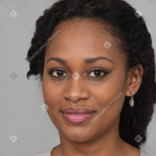 Joyful black young-adult female with long  black hair and brown eyes