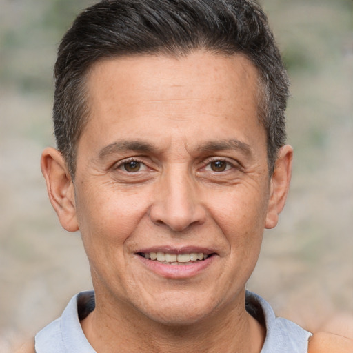 Joyful white adult male with short  brown hair and brown eyes