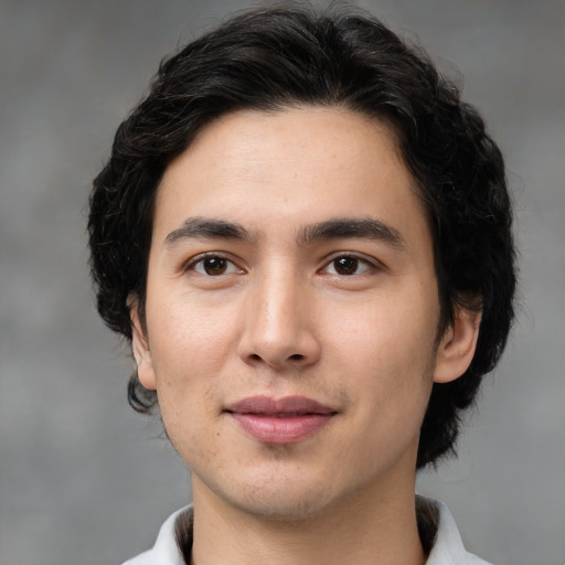 Joyful white young-adult male with medium  black hair and brown eyes