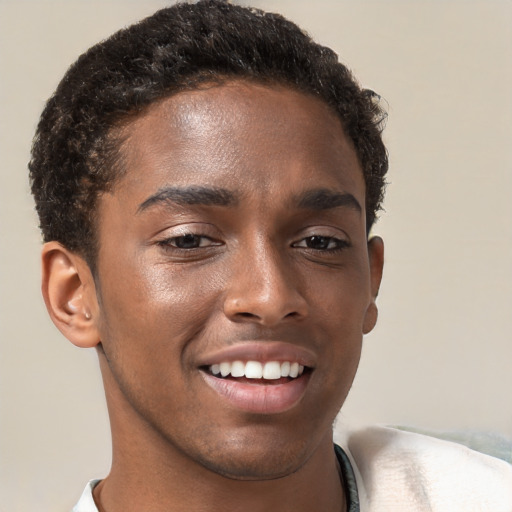 Joyful black young-adult male with short  brown hair and brown eyes