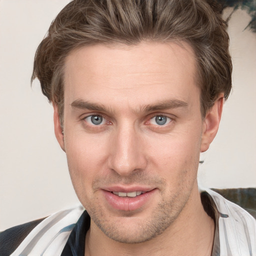 Joyful white young-adult male with short  brown hair and grey eyes