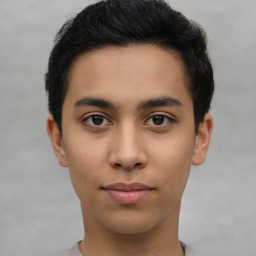 Joyful latino young-adult male with short  brown hair and brown eyes