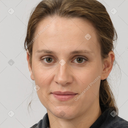 Joyful white adult female with medium  brown hair and grey eyes