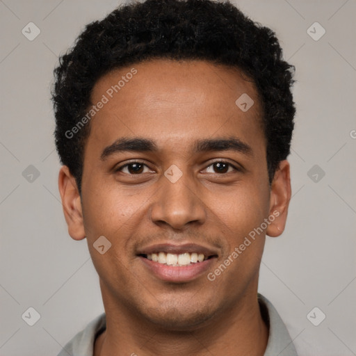 Joyful black young-adult male with short  black hair and brown eyes