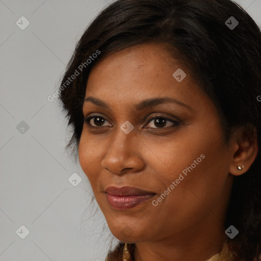 Joyful black young-adult female with long  brown hair and brown eyes