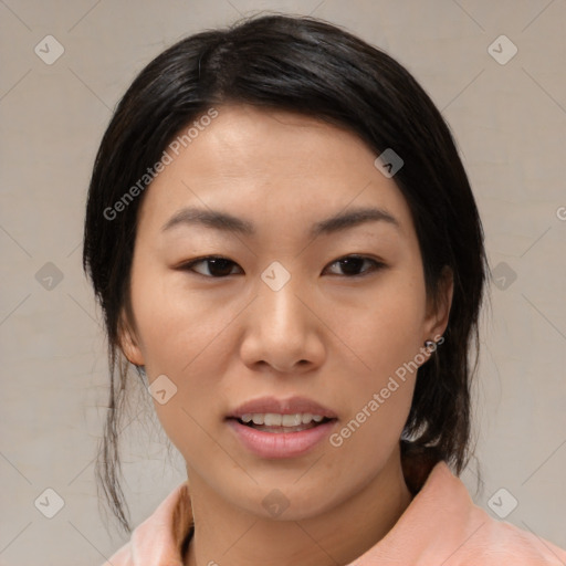 Joyful asian young-adult female with medium  black hair and brown eyes