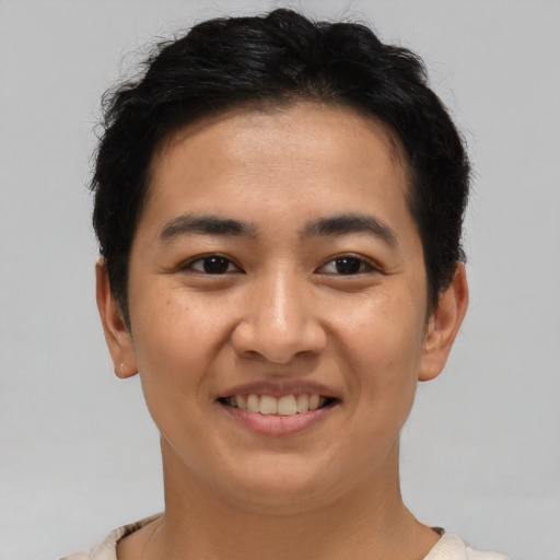 Joyful asian young-adult male with short  brown hair and brown eyes