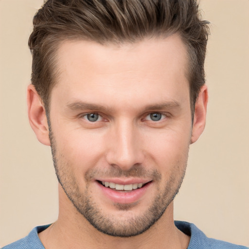 Joyful white young-adult male with short  brown hair and grey eyes