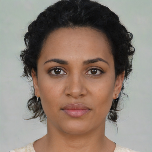 Joyful latino young-adult female with medium  black hair and brown eyes