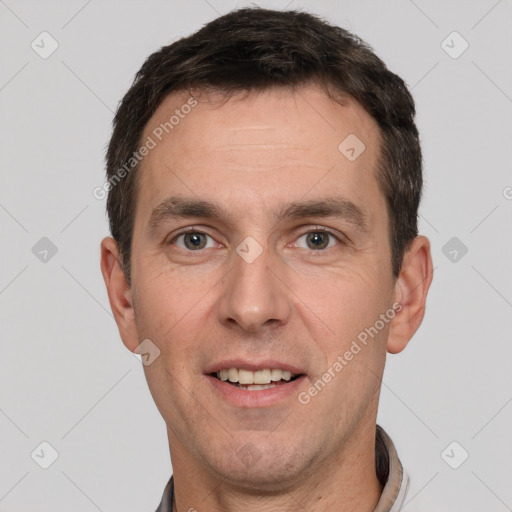 Joyful white adult male with short  brown hair and brown eyes