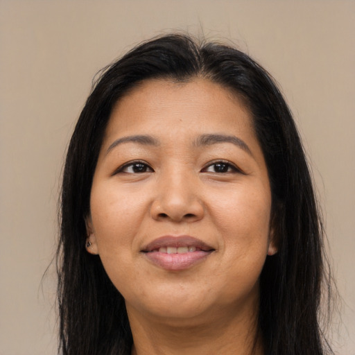 Joyful asian adult female with long  brown hair and brown eyes