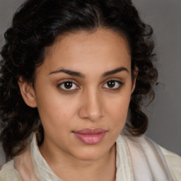 Joyful latino young-adult female with medium  brown hair and brown eyes