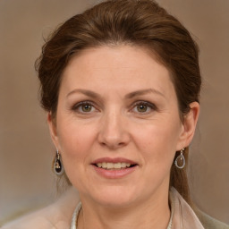 Joyful white adult female with medium  brown hair and grey eyes