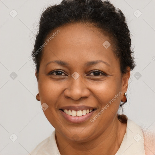 Joyful black adult female with short  brown hair and brown eyes