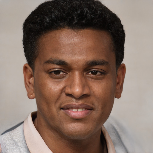 Joyful latino young-adult male with short  brown hair and brown eyes