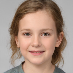 Joyful white child female with medium  brown hair and grey eyes