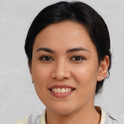 Joyful latino young-adult female with medium  brown hair and brown eyes