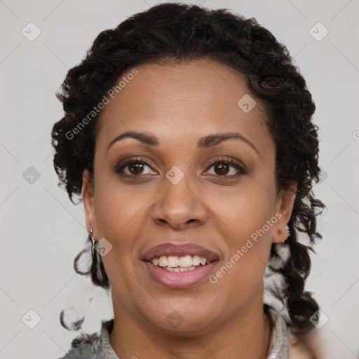 Joyful black adult female with short  brown hair and brown eyes