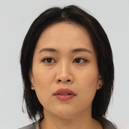 Neutral asian young-adult female with medium  brown hair and brown eyes