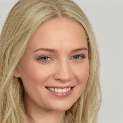 Joyful white young-adult female with long  blond hair and blue eyes