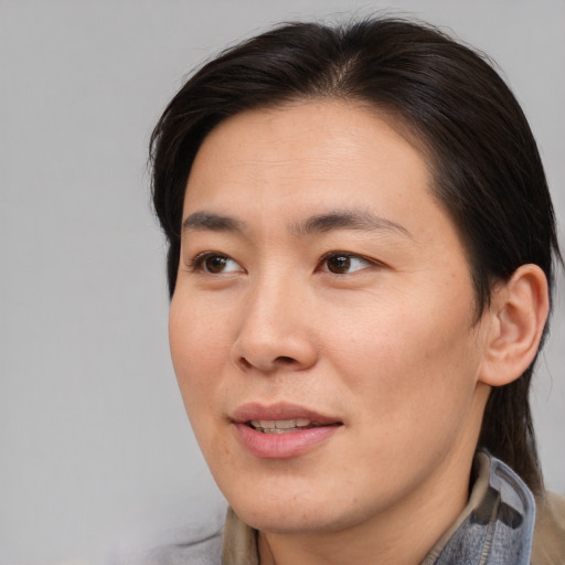 Joyful asian adult male with medium  brown hair and brown eyes