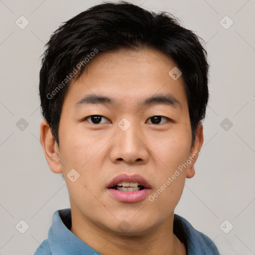 Joyful asian young-adult male with short  black hair and brown eyes