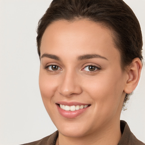 Joyful white young-adult female with long  brown hair and brown eyes