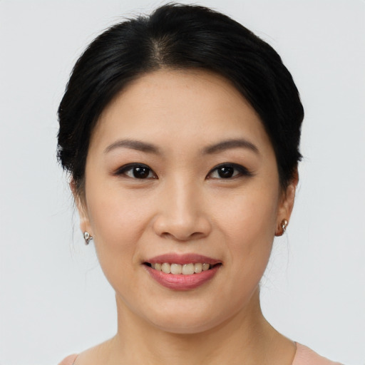 Joyful asian young-adult female with short  brown hair and brown eyes