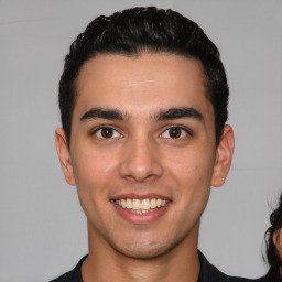 Joyful white young-adult male with short  black hair and brown eyes