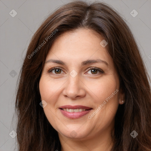 Joyful white adult female with long  brown hair and brown eyes