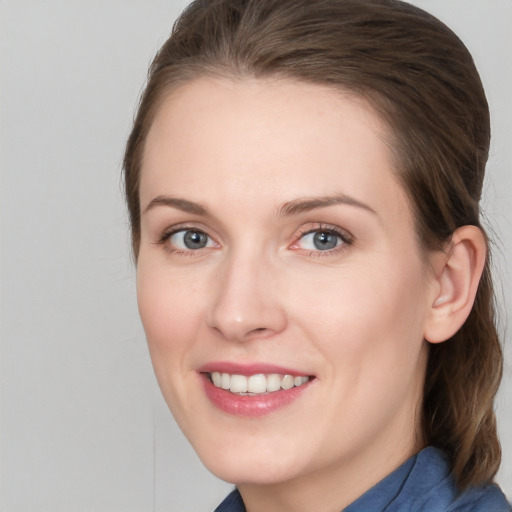 Joyful white young-adult female with medium  brown hair and blue eyes