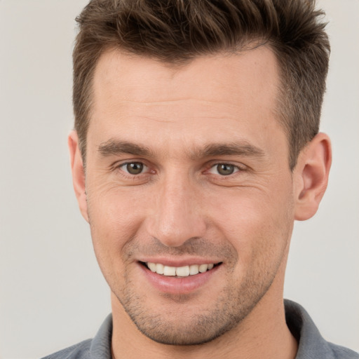 Joyful white young-adult male with short  brown hair and brown eyes