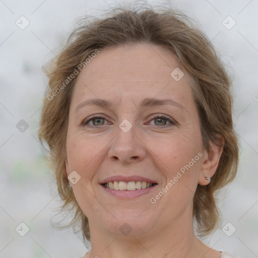 Joyful white adult female with medium  brown hair and grey eyes