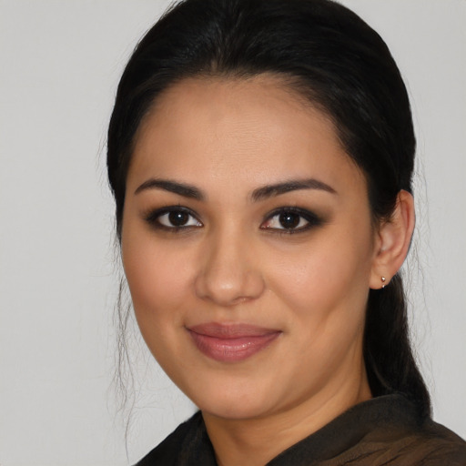 Joyful latino young-adult female with long  black hair and brown eyes