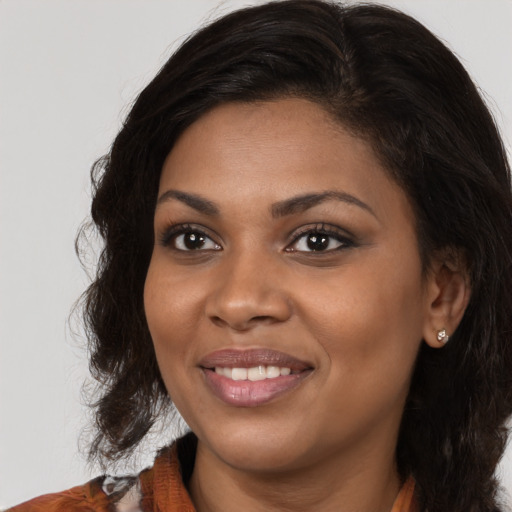 Joyful black young-adult female with medium  brown hair and brown eyes