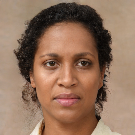 Neutral black adult female with medium  brown hair and brown eyes