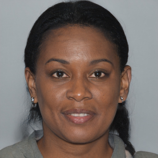 Joyful black young-adult female with medium  brown hair and brown eyes