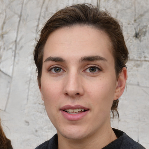 Joyful white young-adult female with short  brown hair and brown eyes