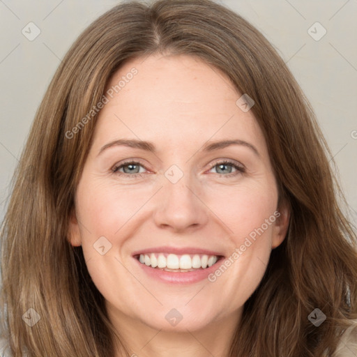 Joyful white adult female with long  brown hair and green eyes