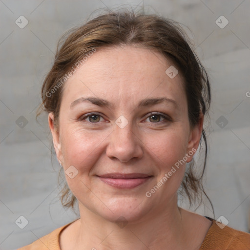 Joyful white adult female with medium  brown hair and grey eyes