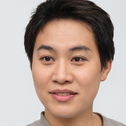 Joyful asian young-adult male with short  brown hair and brown eyes