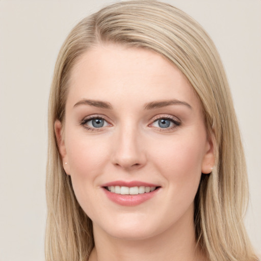 Joyful white young-adult female with long  brown hair and blue eyes