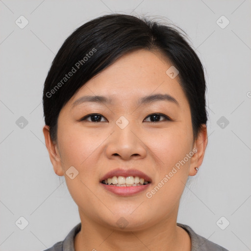 Joyful asian young-adult female with short  black hair and brown eyes