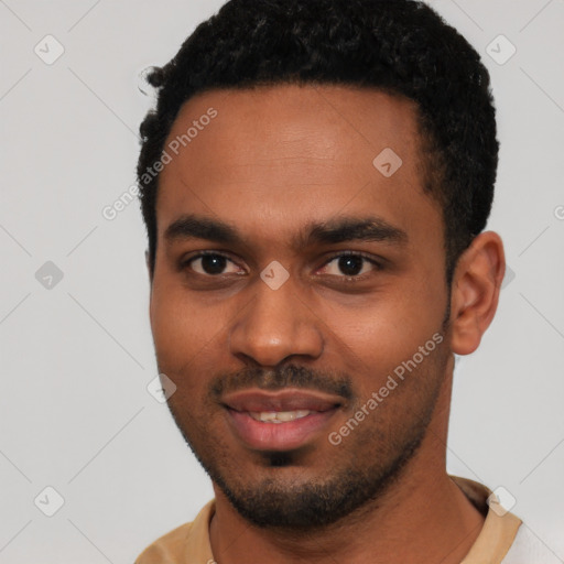 Joyful black young-adult male with short  black hair and brown eyes