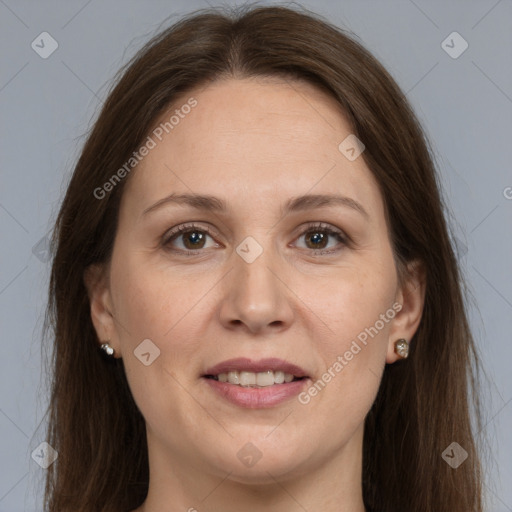 Joyful white adult female with long  brown hair and grey eyes