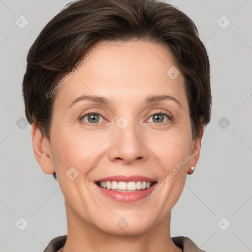 Joyful white adult female with short  brown hair and grey eyes