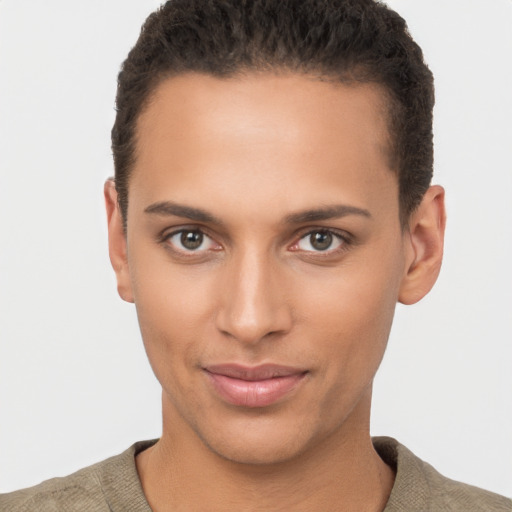 Joyful latino young-adult male with short  brown hair and brown eyes