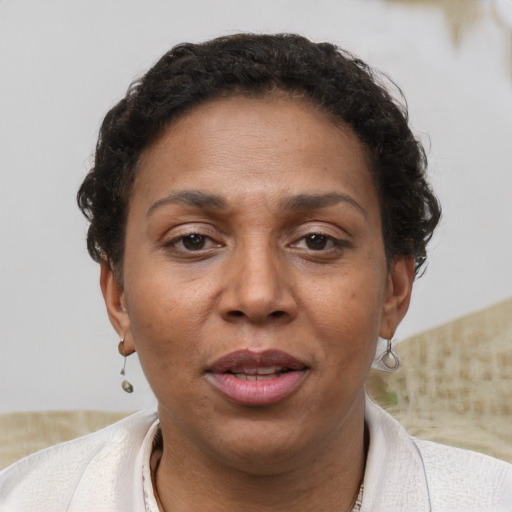 Joyful latino adult female with short  brown hair and brown eyes