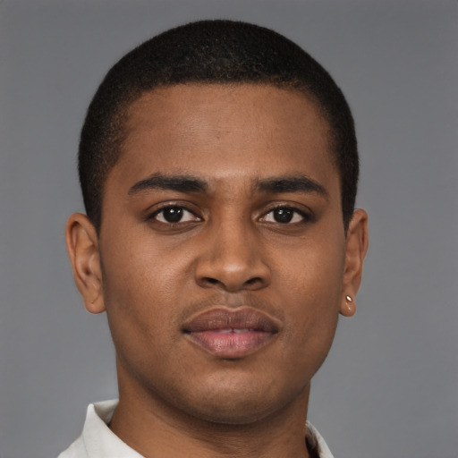 Joyful black young-adult male with short  brown hair and brown eyes